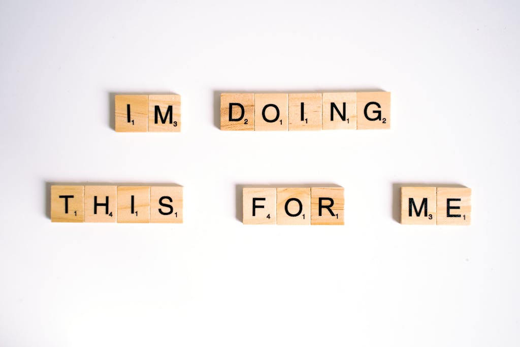 Close-Up Shot of Scrabble Tiles on a White Surface