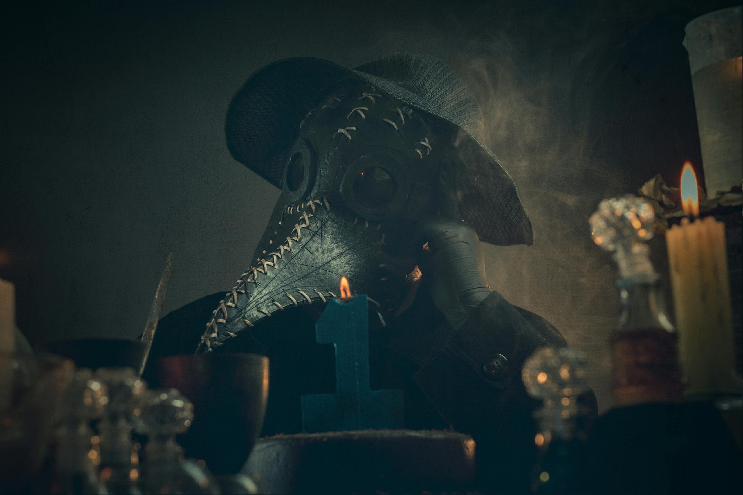 A Person Wearing Black Beaked Mask